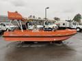 A 2008 Fassmer 20 Foot Fast Rescue boat in bright orange with a streamlined design and a small cabin at the front