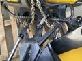 Close-up of a 2000 Fisner XV2 snowplow attachment featuring metal components chains and hydraulic connections