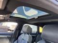 Interior view of a 2016 Audi A3 showcasing leather seats and a panoramic sunroof above the front seating area