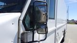 A white 2006 Ford Econoline with visible side mirrors and a large cargo area