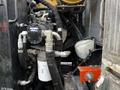 Close-up of the machinery components of a 2007 Tennant Sentinel including hoses valves and filters