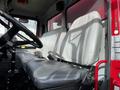 Interior view of a 1994 Freightliner FL80 truck showing two gray seats and the steering wheel