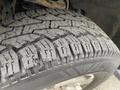 Close-up of a treaded tire from a 2014 Ford F-150 showcasing its detailed patterns and textured surface