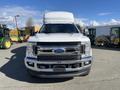 A white 2019 Ford F-350 Super Duty truck with a large box on the back is shown from the front view