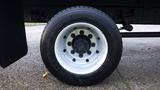 The image shows a close-up of the tire and wheel of a 2008 Ford F-650 with a black tire and a silver, multi-spoke wheel design