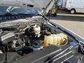 A 2019 Ford F-350 SD engine bay showing various components including a coolant reservoir and fluid containers