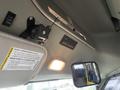 Interior view of a 2012 Chevrolet Express showing the overhead console with switches and a rearview mirror