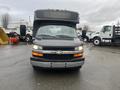 A 2017 Chevrolet Express prominently featuring its front view with a distinctive Chevrolet emblem and large windshield