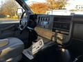 The interior of a 2017 Chevrolet Express featuring a dashboard with radio controls and air vents alongside a gray driver's seat