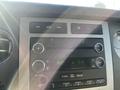 Dashboard controls of a 2013 Ford Expedition featuring audio system buttons and display with time and radio frequency settings