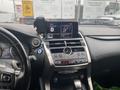 Interior dashboard of a 2021 Lexus NX 300 featuring a touchscreen display a round climate control dial and various buttons for vehicle settings and media controls