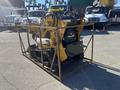 A yellow 2024 AGT KTT23 Mini Skid Steer enclosed in a metal frame with tracks in the back and wheels in the front