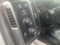 Interior controls and switches of a 2015 Chevrolet Silverado 3500HD featuring knobs for temperature and audio settings