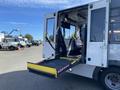 A 2017 Chevrolet Express showing its rear with an extended wheelchair ramp and accessible seating inside