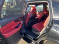 Interior of a 2023 Acura MDX featuring red leather seats and modern dashboard design with multiple controls and a central display