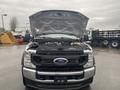 A 2021 Ford F-550 with its hood raised revealing the engine compartment