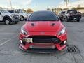 A red 2018 Ford Focus RS with a sporty design featuring a low front bumper large air intakes and a distinctive grille