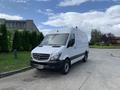 A white 2017 Mercedes-Benz Sprinter van parked on a roadway with the front view prominently displayed