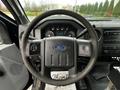 Steering wheel and dashboard of a 2012 Ford F-550 featuring the Ford logo and various instrument gauges