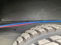 A close-up view of the tire and part of the interior structure of a 2011 Ford Utilimaster Food Truck showing visible wires in blue and red running along the interior wall