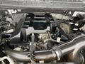 A close-up view of the engine compartment of a 2017 Ford F-150 showcasing the engine cover and various components including hoses and connectors