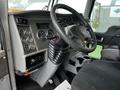 Interior view of a 2014 Kenworth T370 truck featuring a steering wheel and dashboard with gauges and controls