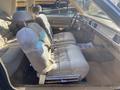 Interior of a 1982 Mercury Grand Marquis featuring plush beige upholstery and a spacious front seating area with seatbelts