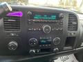 Dashboard of a 2013 Chevrolet Silverado Hybrid featuring audio controls and a digital display showing radio settings and time