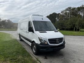 A white 2016 Mercedes-Benz Sprinter van parked with a high roof and sleek front design