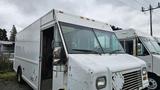 A white 2006 Ford Econoline truck with a distinct boxy shape and large windshield showing signs of wear and age