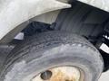 Close-up of a worn tire on a 2018 International 26 Foot Cube truck showing visible tread and rust on the wheel rim