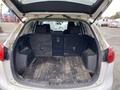 The interior of a 2016 Mazda CX-5 with the rear seats folded down showing a spacious and clean cargo area with a wooden floor and black side panels