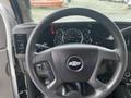 The interior view of a 2017 Chevrolet Express showing the steering wheel dashboard gauges and control buttons