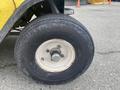 Close-up of a tire mounted on a wheel of a 2000 Ez-go Industrial 800 showing tread patterns and a metallic rim