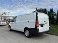 A 2019 Mercedes-Benz Metris van in white with black accents parked on a concrete surface showing its side and rear view