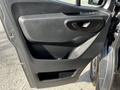 The interior door panel of a 2021 Mercedes-Benz Sprinter featuring a sleek design with a handle and control buttons