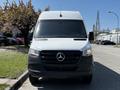 A white 2022 Mercedes-Benz Sprinter van is positioned facing forward with a black grille and the Mercedes-Benz logo prominently displayed in the center