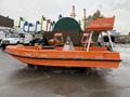 A 2008 Fassmer 20 Foot Fast Rescue boat in bright orange with two seats and a flat deck designed for quick emergency response and rescue operations