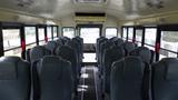 Interior of a 2015 International PC105 school bus featuring gray seats arranged in rows facing forward