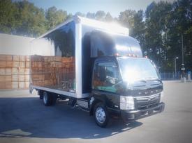 A black 2013 Mitsubishi Fuso FE 160 box truck with a shiny metal cargo area and a distinctive curved hood design