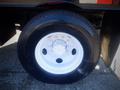 A close-up view of a wheel and tire of a 2006 Ford F-650 featuring a black tire with white rim and visible lug nuts