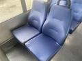 Two blue fabric seats from a 2017 Chevrolet Express with noticeable wear and tear on the surface