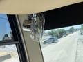 A chrome mini fan mounted on the interior ceiling of a motorhome