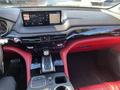 Interior of a 2023 Acura MDX featuring a modern dashboard red leather seats a touchscreen display and a central control console