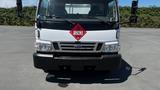 A white 2006 Ford LCF 550 truck with a red diamond hazard sign featuring the number 1263 on the front grille