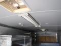 Interior view of a 2010 Forest River Enclosed trailer featuring metal shelves and overhead lighting