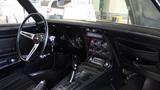 Interior view of a 1971 Chevrolet Corvette Stingray showcasing a black dashboard classic gauges and a stylish gear shift