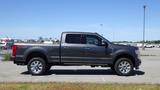 A 2017 Ford F-350 Super Duty pickup truck in gray with chrome wheels parked on a paved surface