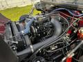 Close-up of the engine of a 1994 Freightliner FL80 showcasing various hoses wires and engine components