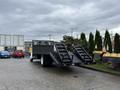 A 2008 Sterling Acterra truck with a flatbed and dual ramps at the back, designed for transporting heavy loads.